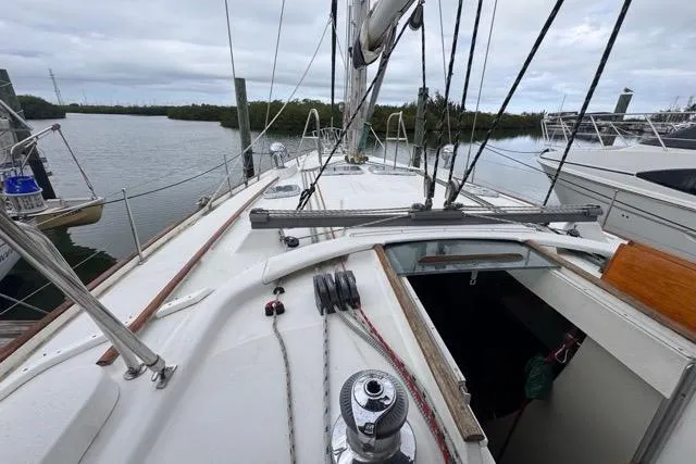 Slide: The Image of 1996 Beneteau 50 sailboat deck view, docked in a marina. - 51