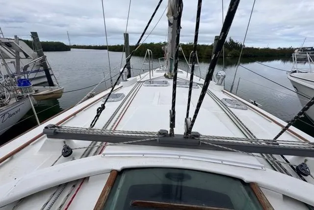 Slide: The Image of Deck view of a 1996 Beneteau 50 sailboat docked in a marina. - 53