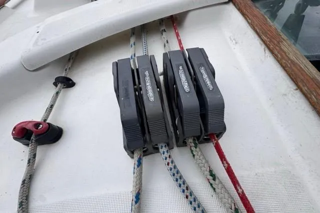 Slide: The Image of Deck of 1996 Beneteau 50 sailboat with rope clutches and lines. - 54