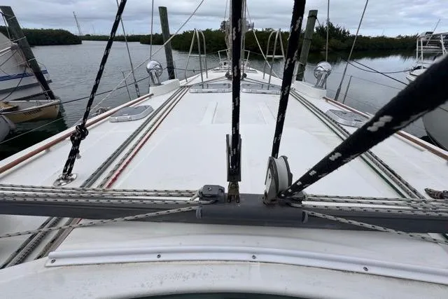 Slide: The Image of Deck view of a 1996 Beneteau 50 sailboat, featuring rigging and mooring lines. - 56