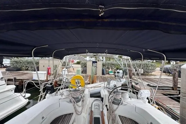 Slide: The Image of 1996 Beneteau 50 sailboat cockpit with canopy, docked at marina. - 60