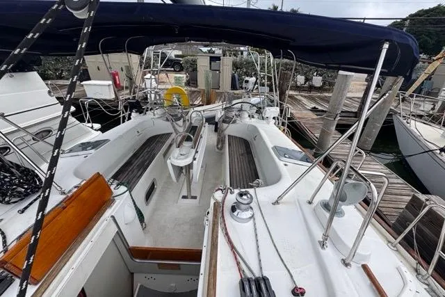 Slide: The Image of Cockpit view of a 1996 Beneteau 50 sailboat docked at a marina. - 62