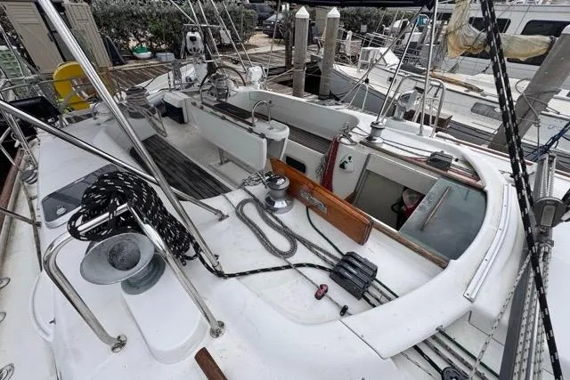 Slide: The Image of 1996 Beneteau 50 sailboat deck with winches, ropes, and cockpit area. - 64