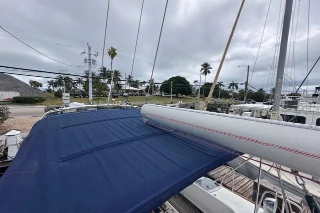 Slide: The Image of Sailboat deck view of 1996 Beneteau 50 with blue canopy and mast. - 65