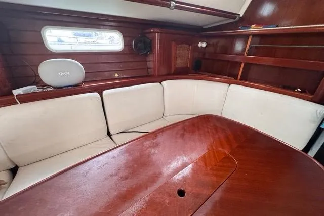 Slide: The Image of Interior of 1996 Beneteau 50 yacht with wooden table and cushioned seating. - 71