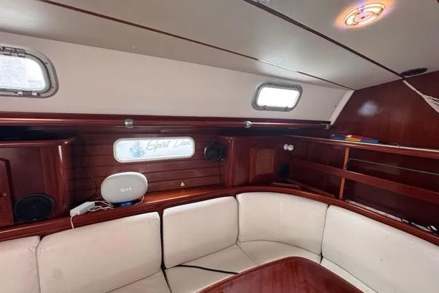 Slide: The Image of Interior of 1996 Beneteau 50 yacht with white seating and wooden accents. - 73