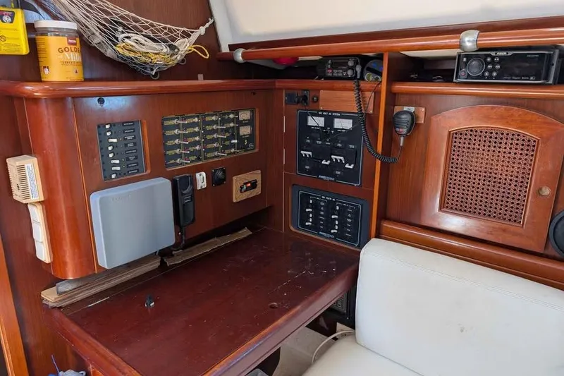 Slide: The Image of Navigation station of a 1996 Beneteau 50 yacht with control panels and equipment. - 76