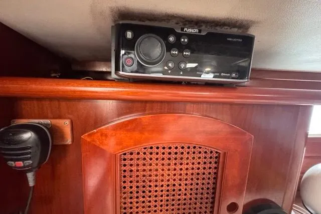 Slide: The Image of Interior of 1996 Beneteau 50 yacht with Fusion audio system and wooden cabinetry. - 79