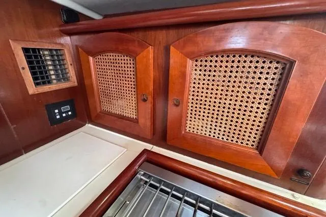 Slide: The Image of Interior of 1996 Beneteau 50 yacht with wooden cabinets and ventilation grilles. - 85