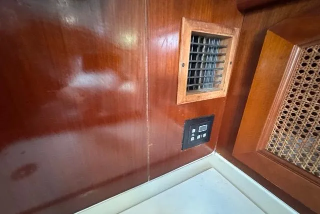 Slide: The Image of Interior of a 1996 Beneteau 50 yacht, featuring wooden paneling and ventilation grille. - 86