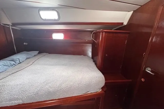 Slide: The Image of Cozy cabin interior of a 1996 Beneteau 50 sailboat with wooden furnishings. - 92