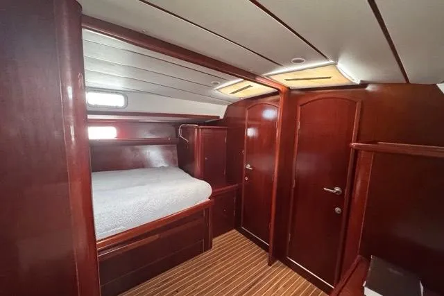 Slide: The Image of Luxurious cabin interior of 1996 Beneteau 50 yacht with wooden finish and cozy bed. - 95