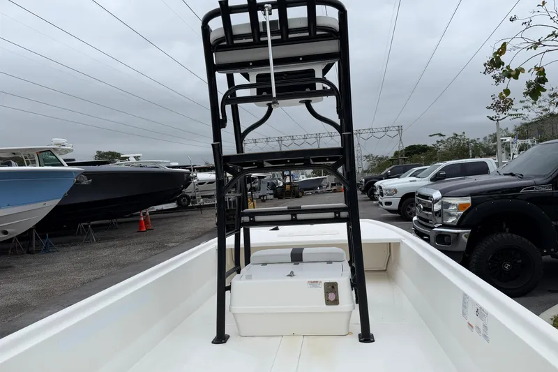 Slide: The Image of 2018 Mako Pro Skiff 19 CC Top Drive boat in a marina, overcast sky. - 4