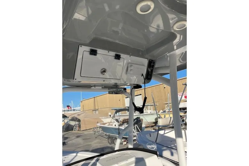 Slide: The Image of 2023 Sea Pro 248 Bay boat console with storage compartment and electronics. - 10