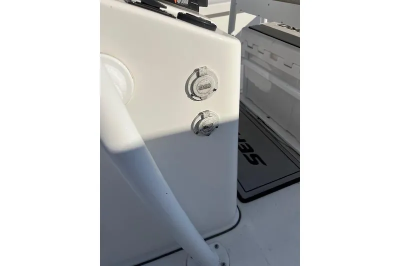 Slide: The Image of 2023 Sea Pro 248 Bay boat interior with control panel and seating area. - 8