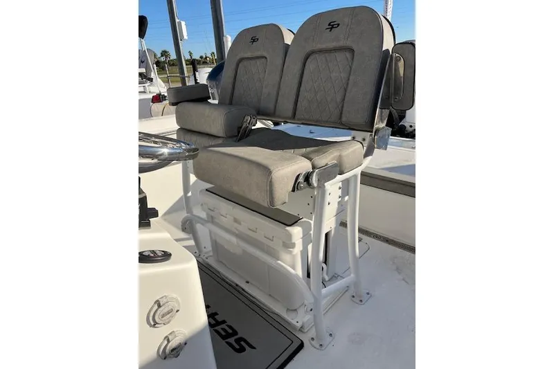 Slide: The Image of 2023 Sea Pro 248 Bay boat seating with gray cushioned seats and white frame. - 9