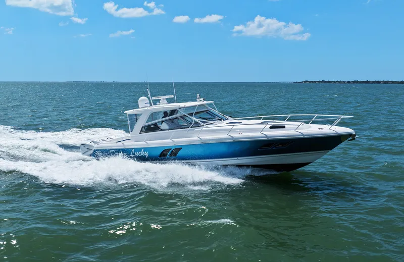The Image of 2019 Intrepid 475 boat cruising on open water under a clear blue sky. - 0