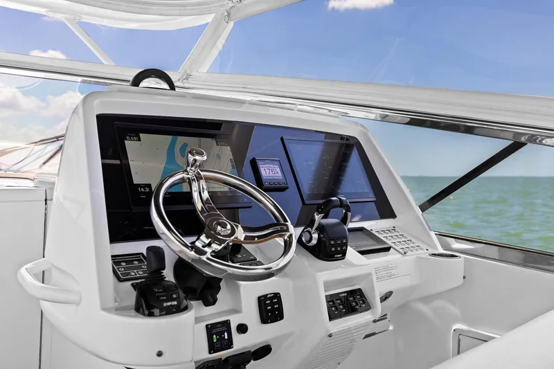 Slide: The Image of 2019 Intrepid 475 helm with modern navigation equipment and ocean view. - 1