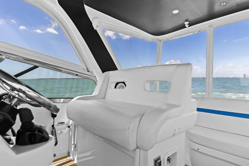 Slide: The Image of Interior of 2019 Intrepid 475 boat with modern helm and ocean view. - 12