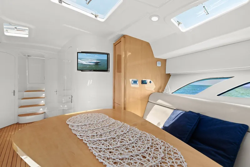 Slide: The Image of Luxurious interior of 2019 Intrepid 475 yacht with elegant seating and wooden table. - 19