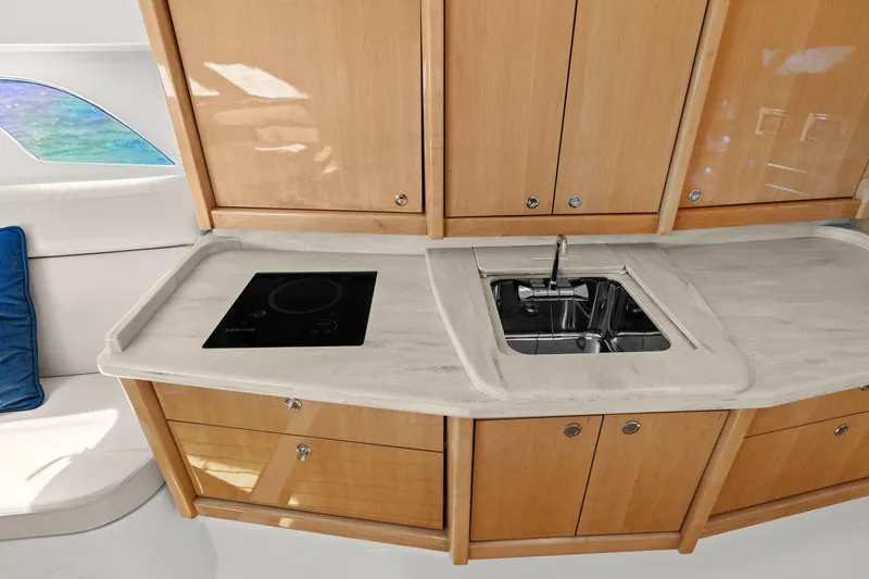 Slide: The Image of Luxurious 2019 Intrepid 475 yacht interior with modern kitchen and wooden cabinetry. - 22