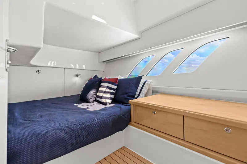 Slide: The Image of Cabin interior of 2019 Intrepid 475 yacht with ocean view windows. - 28