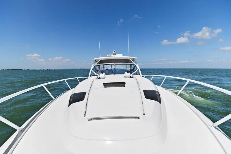 Slide: The Image of Bow view of 2019 Intrepid 475 boat cruising on open sea under blue sky. - 33