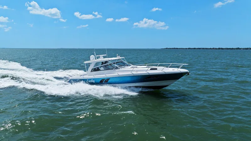 Slide: The Image of 2019 Intrepid 475 boat cruising on open water under a clear blue sky. - 39