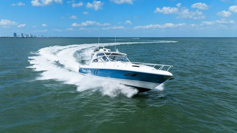 Slide: The Image of 2019 Intrepid 475 boat cruising on open water under a clear blue sky. - 43