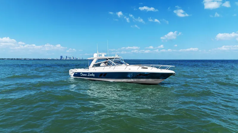 Slide: The Image of 2019 Intrepid 475 boat cruising on open water under a clear blue sky. - 47