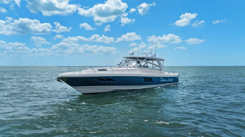 Slide: The Image of 2019 Intrepid 475 boat cruising on open water under a clear blue sky. - 48
