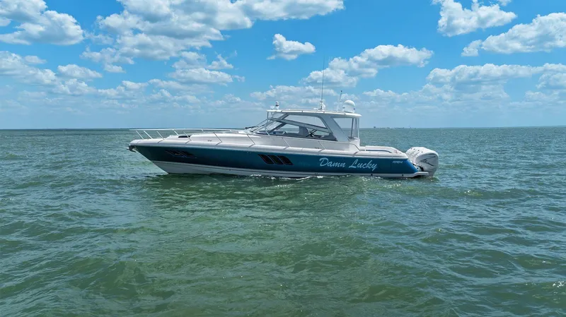 Slide: The Image of 2019 Intrepid 475 boat cruising on open water under a clear blue sky. - 49