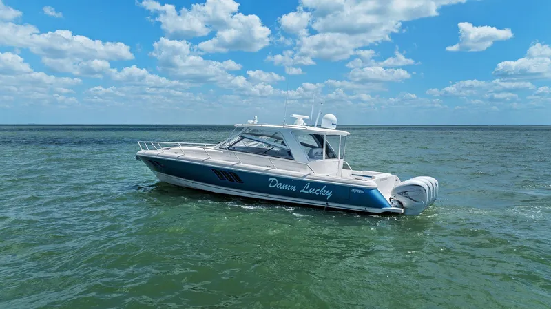 Slide: The Image of 2019 Intrepid 475 boat on open water under a partly cloudy sky. - 50