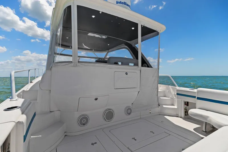 Slide: The Image of 2019 Intrepid 475 yacht deck with white seating and ocean view. - 8