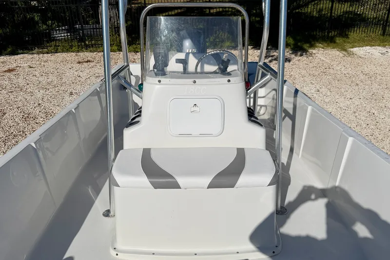 Slide: The Image of 2011 Carolina Cat 18 CC boat interior with steering console and seating. - 10