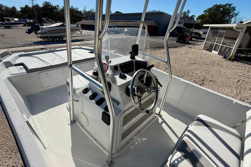 Slide: The Image of 2011 Carolina Cat 18 CC boat interior with steering console and seating. - 13
