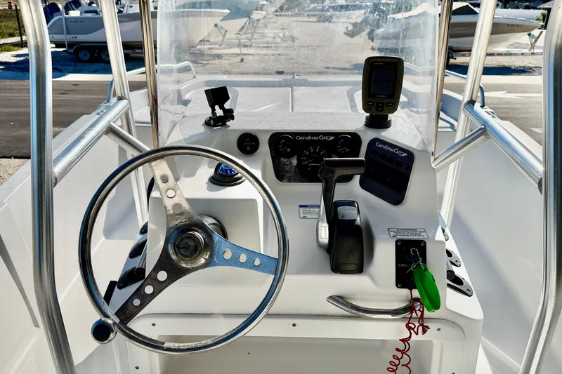 Slide: The Image of 2011 Carolina Cat 18 CC boat console with steering wheel and navigation equipment. - 15