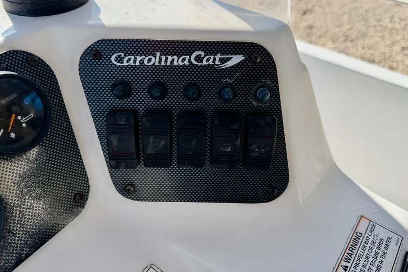 Slide: The Image of Control panel of 2011 Carolina Cat 18 CC boat with switches and gauge. - 16
