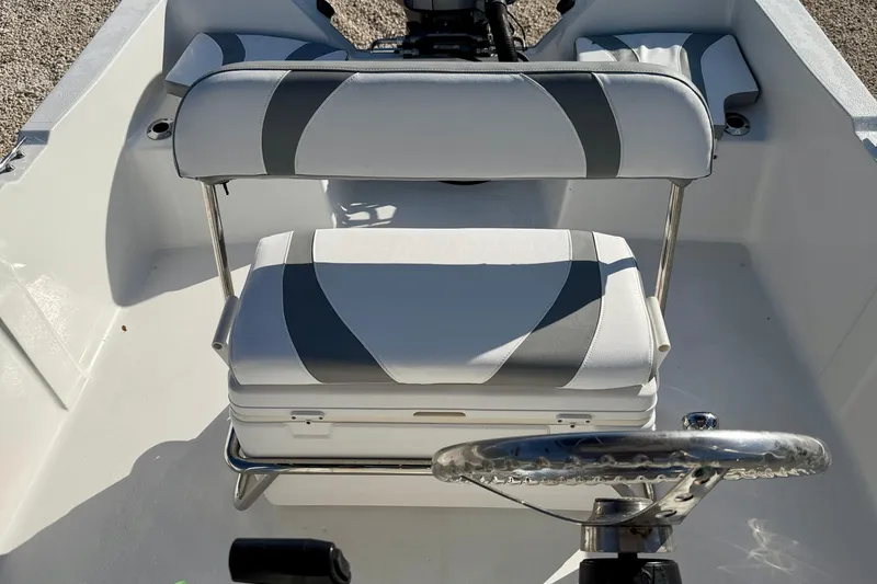 Slide: The Image of 2011 Carolina Cat 18 CC boat interior with cushioned seating and steering wheel. - 22
