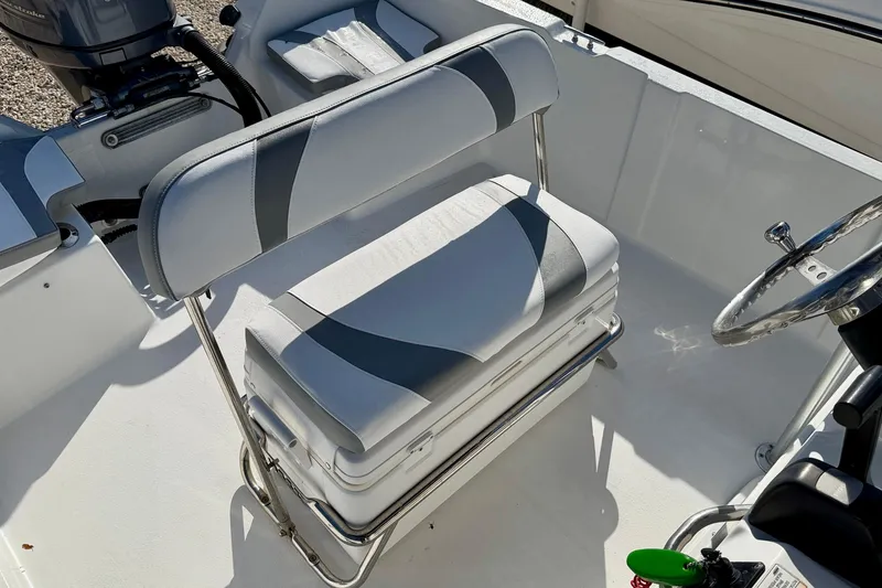 Slide: The Image of 2011 Carolina Cat 18 CC boat interior with cushioned seating and steering wheel. - 23