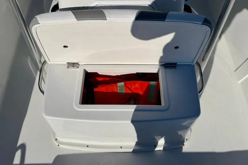 Slide: The Image of Open storage compartment on 2011 Carolina Cat 18 CC boat with safety gear inside. - 25