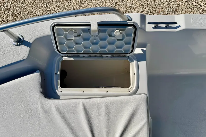 Slide: The Image of Open storage compartment on 2011 Carolina Cat 18 CC boat deck. - 27