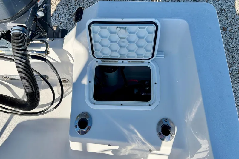 Slide: The Image of 2011 Carolina Cat 18 CC boat with open hatch and visible engine components. - 29