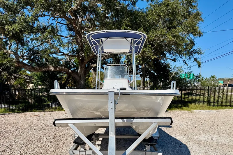 Slide: The Image of 2011 Carolina Cat 18 CC boat on trailer, parked outdoors under a clear blue sky. - 3