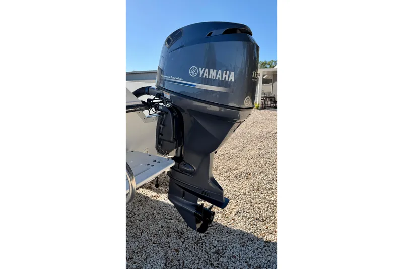 Slide: The Image of Yamaha outboard motor on 2011 Carolina Cat 18 CC boat, parked on gravel. - 30