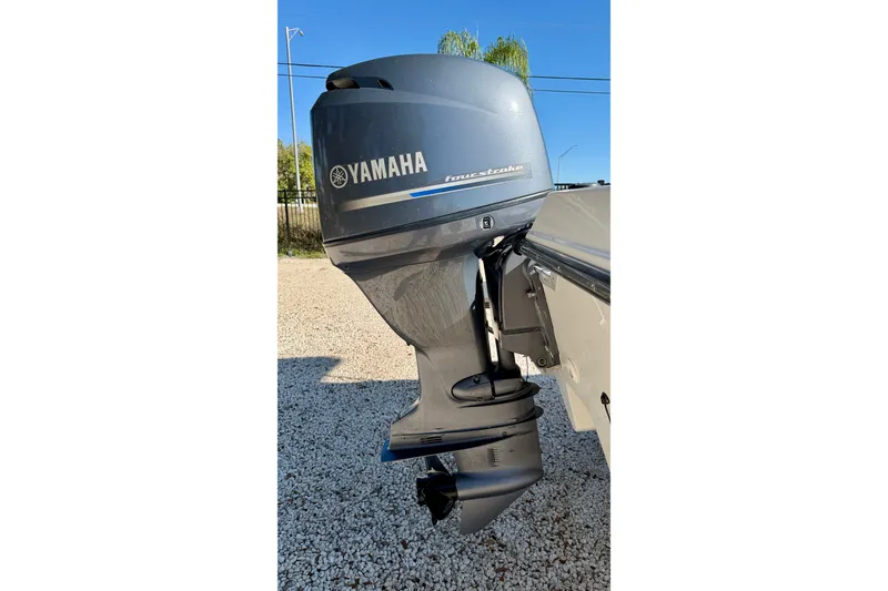 Slide: The Image of Yamaha outboard motor on 2011 Carolina Cat 18 CC boat, parked on gravel. - 32