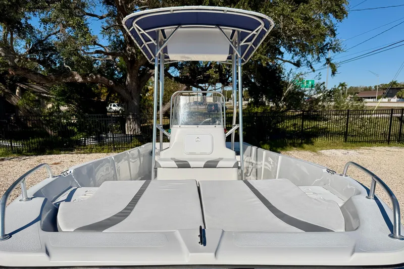 Slide: The Image of 2011 Carolina Cat 18 CC boat with T-top, spacious deck, and seating, outdoors. - 8