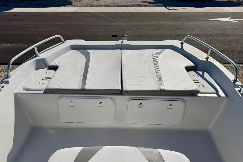 Slide: The Image of 2011 Carolina Cat 18 CC boat interior with cushioned seating and storage compartments. - 9