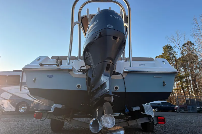 Slide: The Image of 2018 Tidewater 210 LXF boat with Yamaha engine on trailer, parked outdoors. - 2
