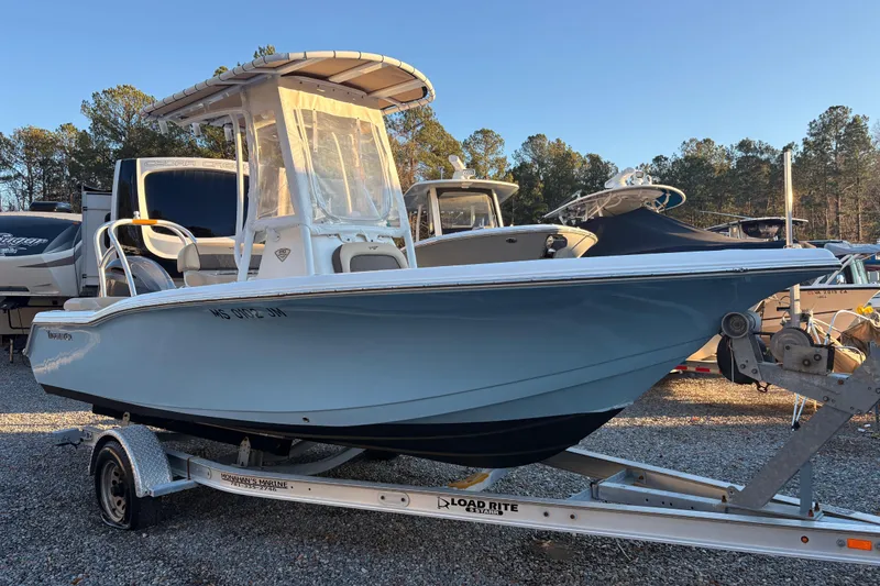 Slide: The Image of 2018 Tidewater 210 LXF boat on trailer, parked outdoors under clear sky. - 4